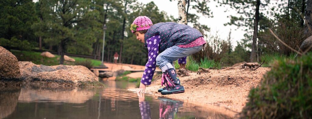 Charlotte playing by the water